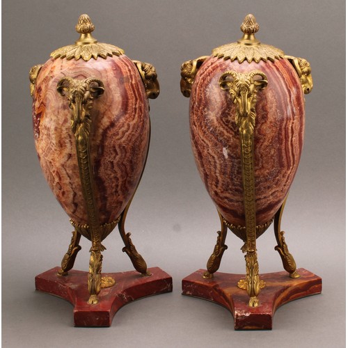 2400 - A pair of Neoclassical gilt bronze mounted alabastro fiorito ovoid urns, the mounts cast as caprine ... 