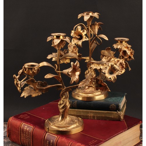 2435 - A pair of 19th century French ormolu three-light candelabra, the branches naturalistically modelled ... 