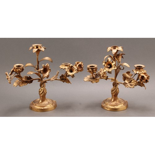 2435 - A pair of 19th century French ormolu three-light candelabra, the branches naturalistically modelled ... 