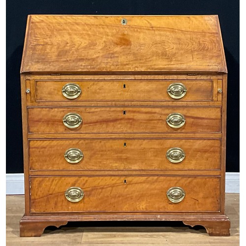 1498 - A George III ash bureau, fall front enclosing a fitted interior above four long graduated drawers, s... 