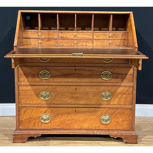 1498 - A George III ash bureau, fall front enclosing a fitted interior above four long graduated drawers, s... 