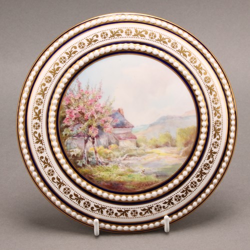 194 - A Royal Crown Derby circular box cover, painted by John Porter Wale, signed, with an English country... 