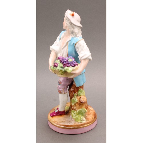 254 - A pair of German porcelain figures, as a grape farmer and his female companion, each carrying a bask... 