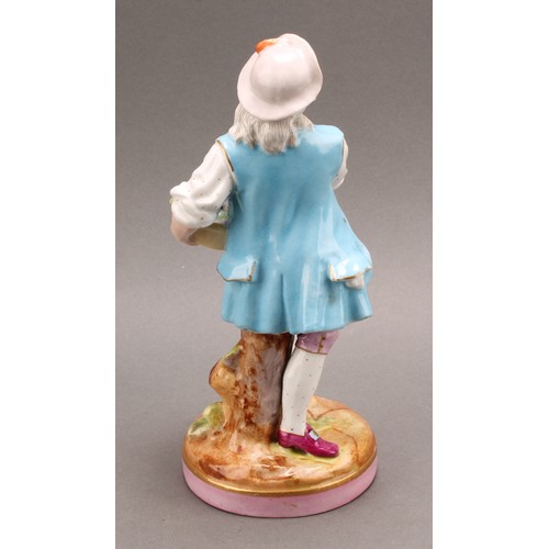 254 - A pair of German porcelain figures, as a grape farmer and his female companion, each carrying a bask... 