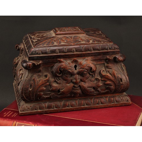 2212 - A 19th century oak sarcophagus table box or casket, boldly carved with 'Green Man' foliate mask and ... 