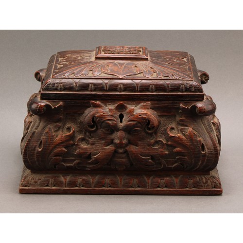 2212 - A 19th century oak sarcophagus table box or casket, boldly carved with 'Green Man' foliate mask and ... 