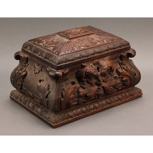 2212 - A 19th century oak sarcophagus table box or casket, boldly carved with 'Green Man' foliate mask and ... 