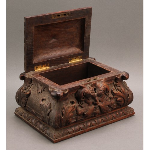 2212 - A 19th century oak sarcophagus table box or casket, boldly carved with 'Green Man' foliate mask and ... 