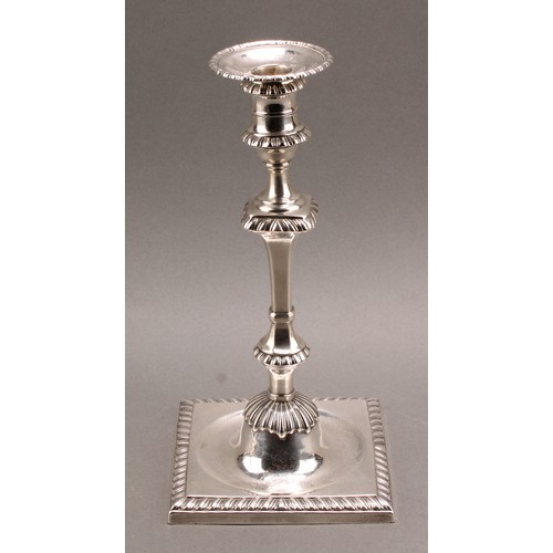 907 - A set of four early George III Scottish silver cast table candlesticks, campana sconces with detacha... 