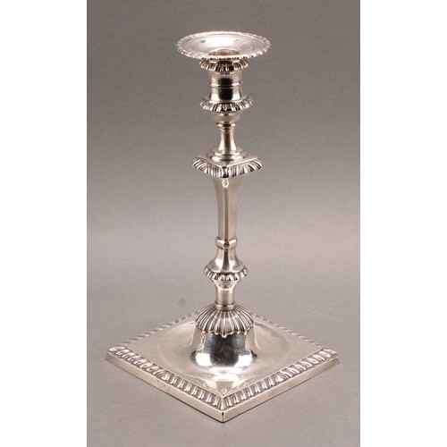 907 - A set of four early George III Scottish silver cast table candlesticks, campana sconces with detacha... 