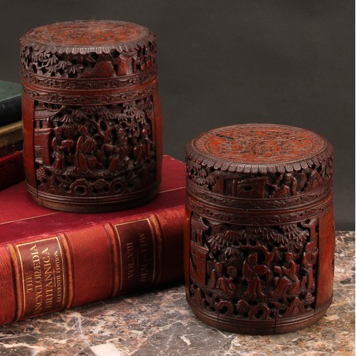 1373 - A pair of Chinese export bamboo tea caddies, each carved with narrative scenes with figures in a lan... 