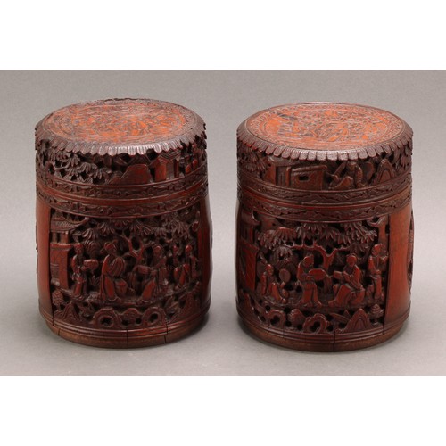 1373 - A pair of Chinese export bamboo tea caddies, each carved with narrative scenes with figures in a lan... 