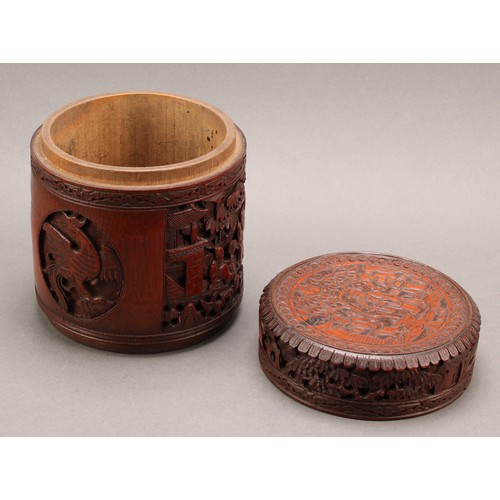 1373 - A pair of Chinese export bamboo tea caddies, each carved with narrative scenes with figures in a lan... 