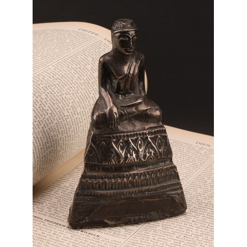 1276 - A Burmese silver coloured metal clad Buddha, typically seated in meditation, 14.5cm high