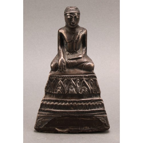 1276 - A Burmese silver coloured metal clad Buddha, typically seated in meditation, 14.5cm high