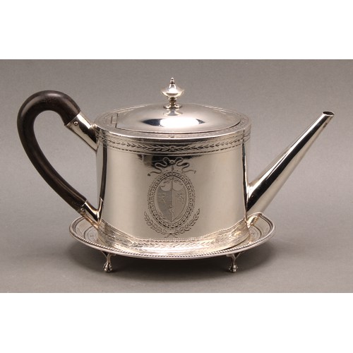 782 - A George III silver oval teapot and stand, hinged domed cover with urnular finial, bright-cut engrav... 