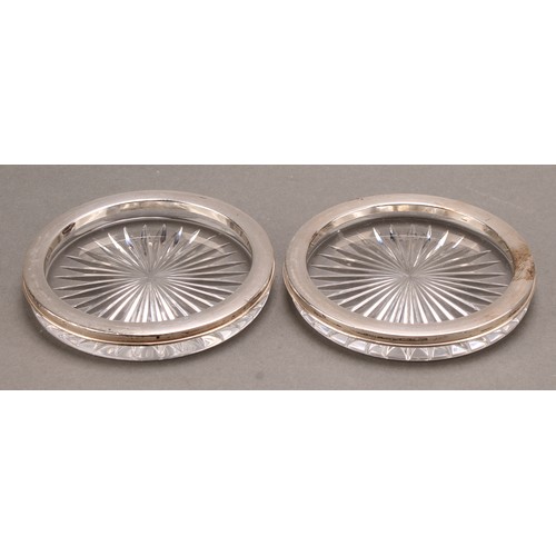 856 - A pair of Continental silver mounted circular glass bottle coasters, star-cut bases, 11.5cm diam, im... 