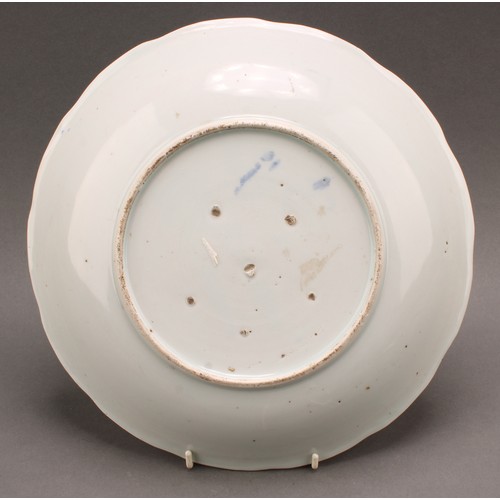 1288 - A 19th century Chinese dish, painted in tones of underglaze blue, depicting a scholar attended by a ... 