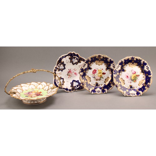 97 - A pair of English porcelain shaped circular plates, the field painted with colourful flowers, cobalt... 