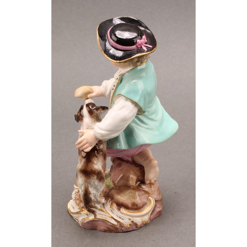 241 - A Meissen porcelain figure, of a boy feeding a dog, painted in polychrome, picked out with gilt, cir... 