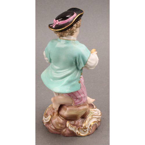 241 - A Meissen porcelain figure, of a boy feeding a dog, painted in polychrome, picked out with gilt, cir... 