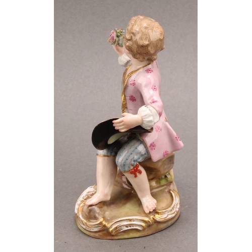 241 - A Meissen porcelain figure, of a boy feeding a dog, painted in polychrome, picked out with gilt, cir... 