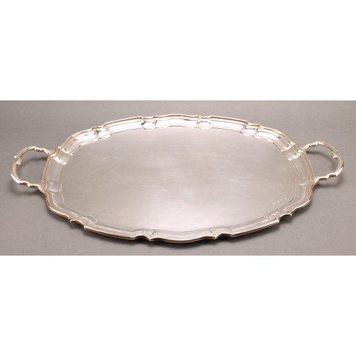 825 - A George V silver shaped oval two-handled serving tray, pie crust border, 56cm wide, Viner's Ltd., S... 