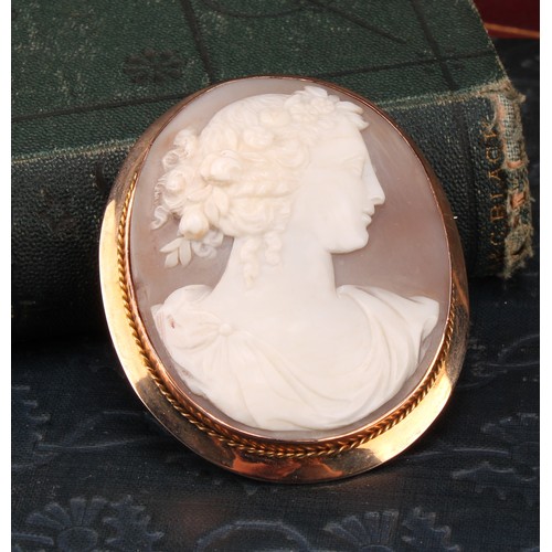 1190 - A 9ct gold mounted shell cameo brooch, carved with a classical beauty in profile, a garland of flowe... 