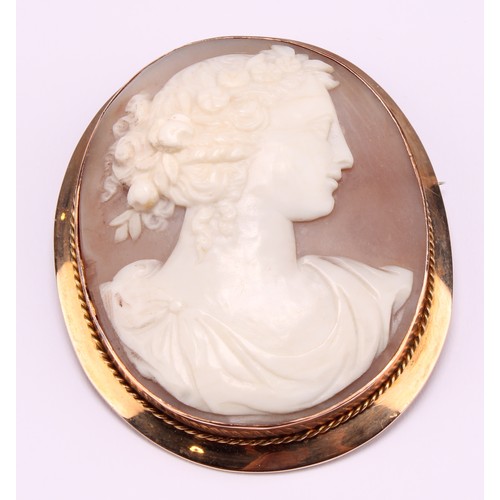 1190 - A 9ct gold mounted shell cameo brooch, carved with a classical beauty in profile, a garland of flowe... 