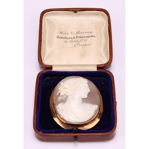 1190 - A 9ct gold mounted shell cameo brooch, carved with a classical beauty in profile, a garland of flowe... 