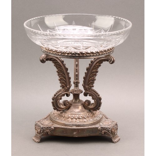 675 - A George IV Old Sheffield Plate table centrepiece, the serpentine triform base with shells and scrol... 