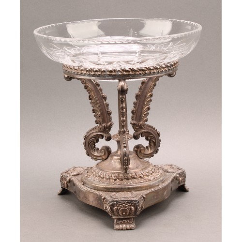 675 - A George IV Old Sheffield Plate table centrepiece, the serpentine triform base with shells and scrol... 