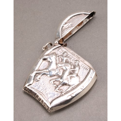 1014 - An early 20th century silver novelty vesta case, embossed with a horse racing scene within a horsesh... 