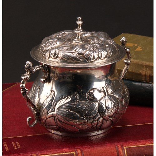 973 - A William & Mary style silver porringer and cover, chased with fruiting foliage, scroll handles cres... 