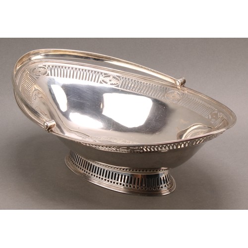 780 - A George III silver navette shaped swing-handled cake basket, pierced and engraved in the Neo-Classi... 