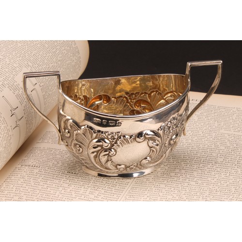 1022 - An Edward VII Rococo Revival silver two-handled sugar basin, chased with flowers and foliate scrolls... 