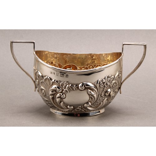 1022 - An Edward VII Rococo Revival silver two-handled sugar basin, chased with flowers and foliate scrolls... 