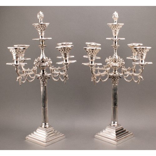 681 - A pair of George III Revival E.P.N.S five-light Corinthian column candelabra, in the Neo-Classical t... 