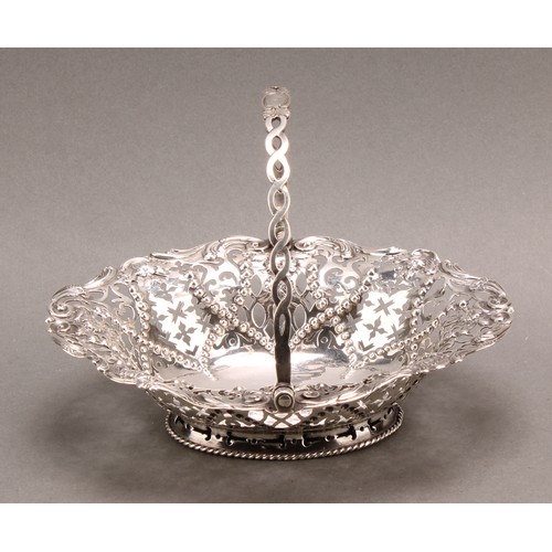 1020 - An early George III silver oval swing handled sweetmeat basket, pierced and chased with flowers, sti... 