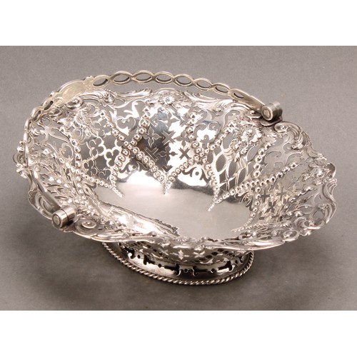 1020 - An early George III silver oval swing handled sweetmeat basket, pierced and chased with flowers, sti... 