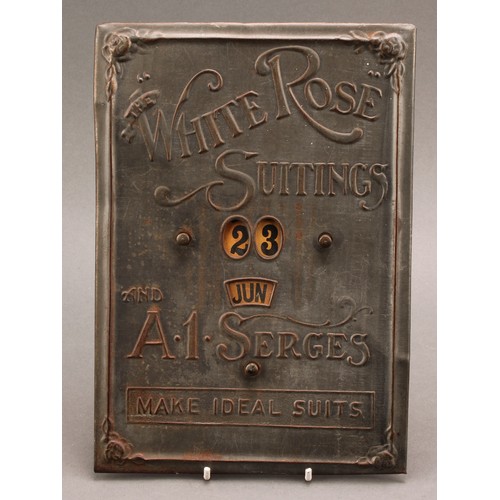 2556 - Advertising - an early 20th century pressed tinplate perpetual calendar, The White Rose  Suitings an... 