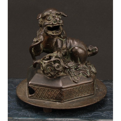 1278 - A Chinese bronze, of a foo dog and snake, hexagonal base, 14cm high overall, c. 1900