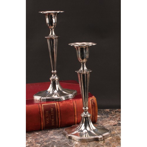 895 - A pair of Victorian silver fluted oval candlesticks, reeded borders, 24cm high, Hawksworth, Eyre & C... 