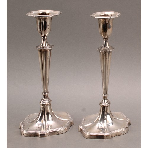 895 - A pair of Victorian silver fluted oval candlesticks, reeded borders, 24cm high, Hawksworth, Eyre & C... 