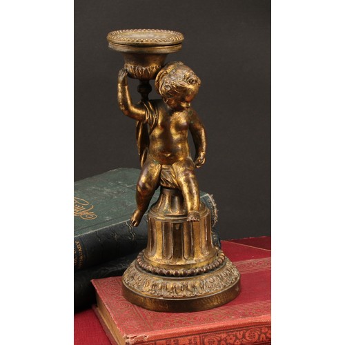 2208 - A 19th century gilt bronze figural candlestick, cast as a scantily clad putti, seated on a fluted co... 