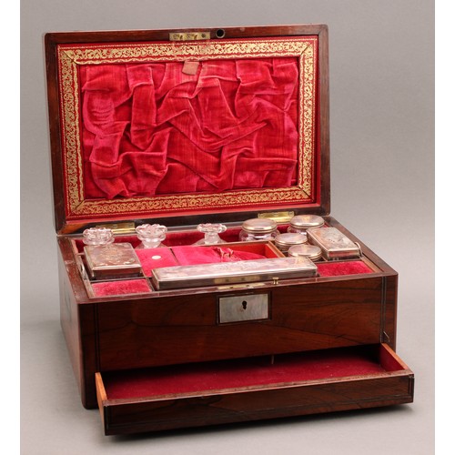 2437 - A Victorian rosewood rectangular dressing box, hinged cover enclosing a fitted interior with bottles... 