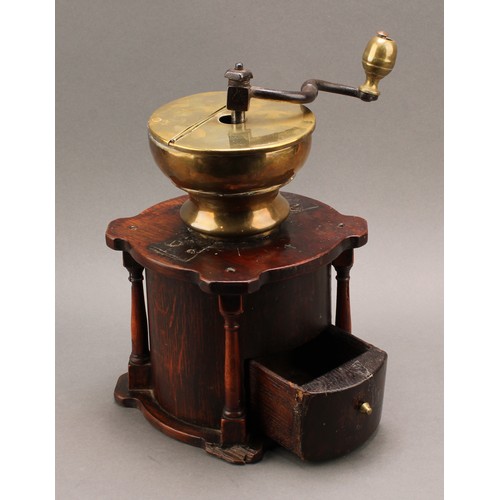 2559 - An 18th century oak country house coffee grinder or mill, iron crank, brass hopper, the architectura... 