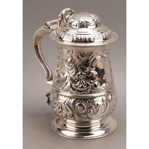 1018 - An early George III silver baluster tankard, hinged domed cover, double-scroll handle, skirted base,... 