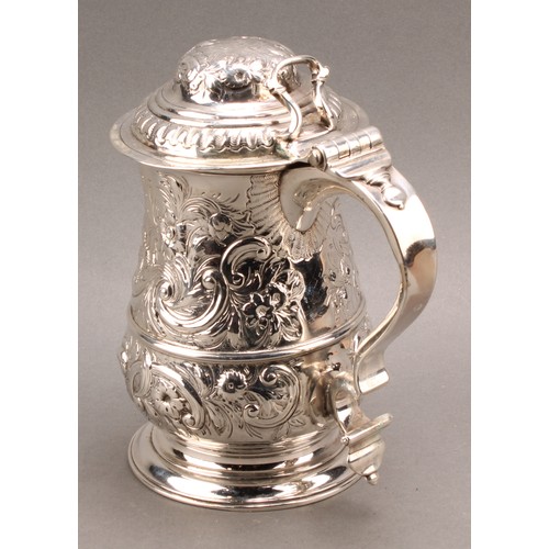 1018 - An early George III silver baluster tankard, hinged domed cover, double-scroll handle, skirted base,... 