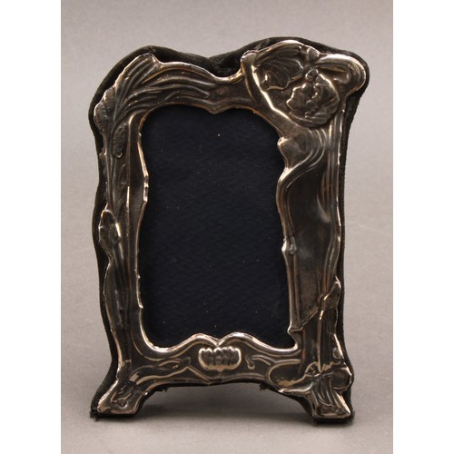 998 - An Art Nouveau style silver easel photograph frame, embossed with a young girl with flowing hairm am... 